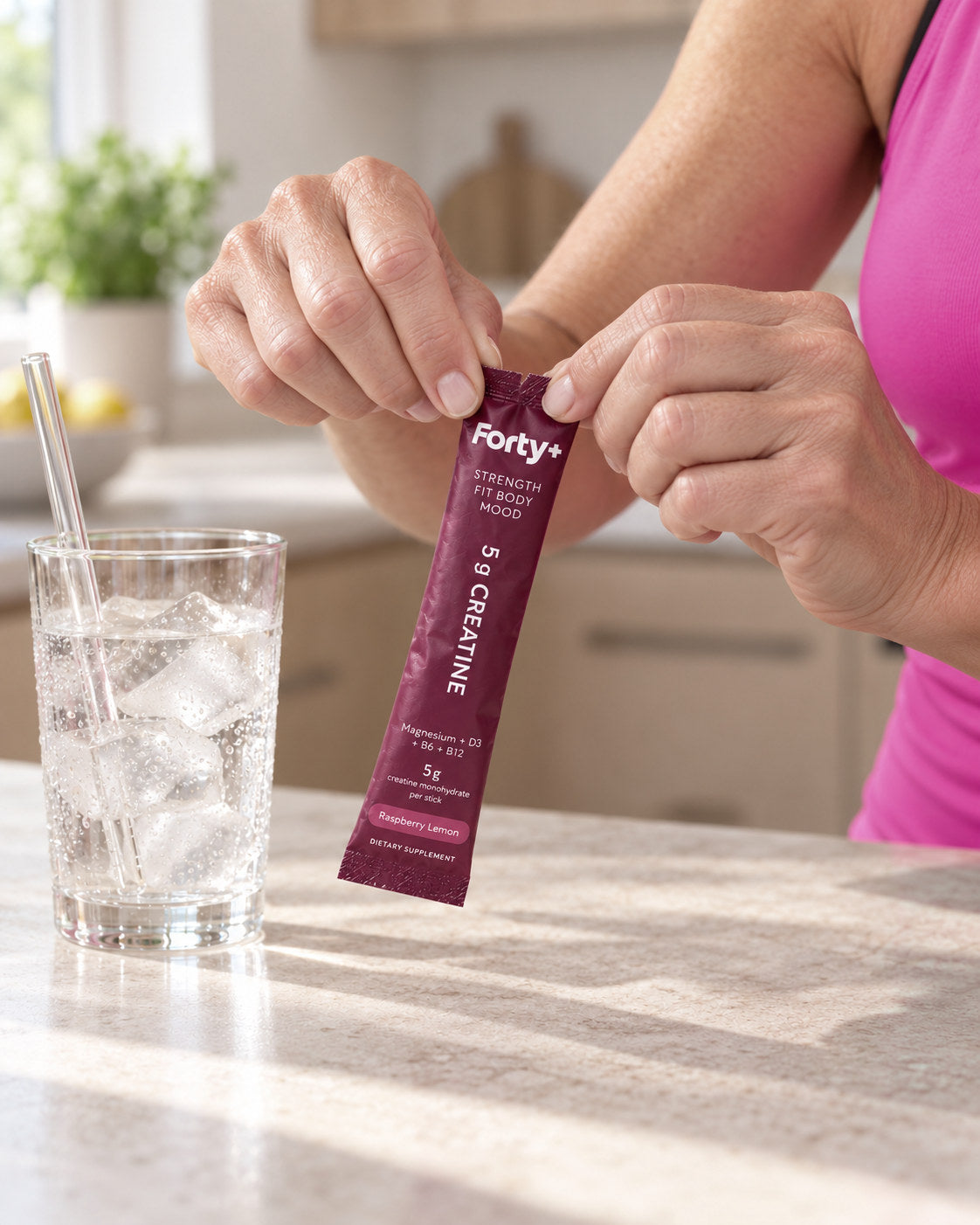 A Forty+ stick ready to open beside a glass.