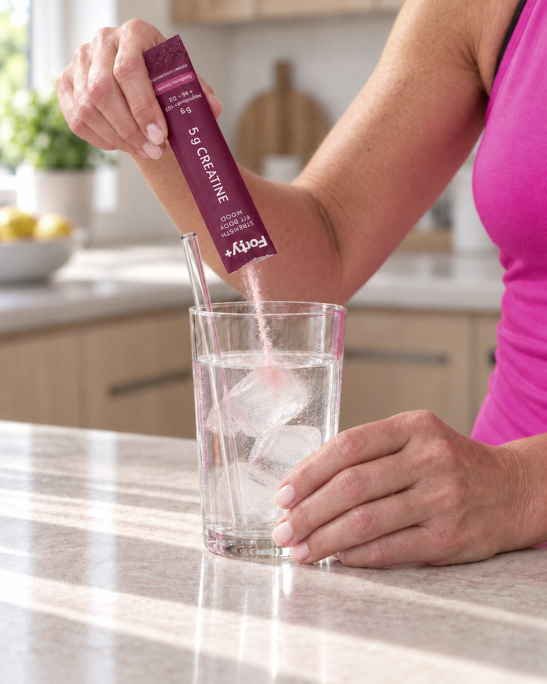 Pouring Forty+ into a glass of water.